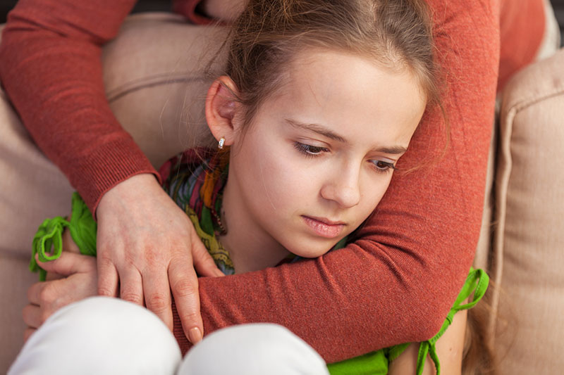 Mother Holding Sad Teenager Girl From Behind Close Up