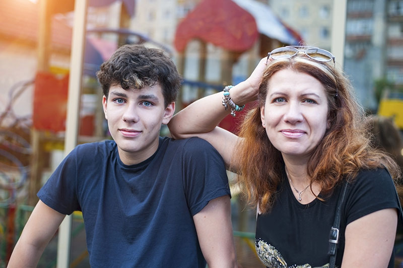 Mom and teenage son talking about child psychiatry specialties